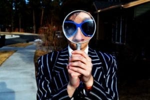 man in a suit with a magnifying glass