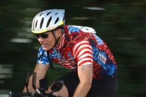 man with a helmet on a bicycle